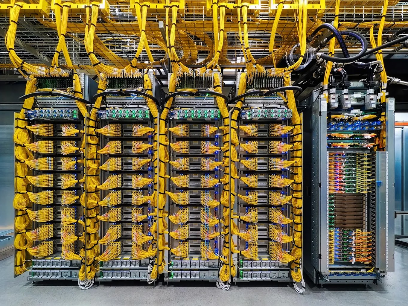 Google Cloud Vera Rubin system with dense yellow network cabling and liquid-cooling lines