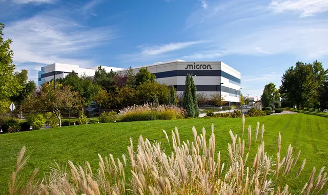 Micron's Boise, Idaho site, with the company name on a white building behind trees and a lawn.