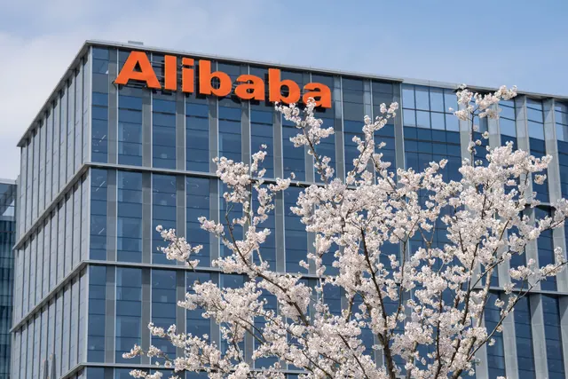 Alibaba headquarters building in Hangzhou framed by spring blossoms